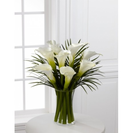 White calla lilies and palm leaves arrangement.